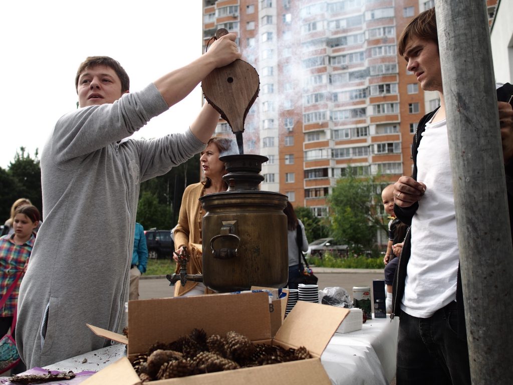 13 августа 2016 года. Троицк. Один из организаторов праздника варенья Евгений Гамза раздувает самовар для горячего чая.