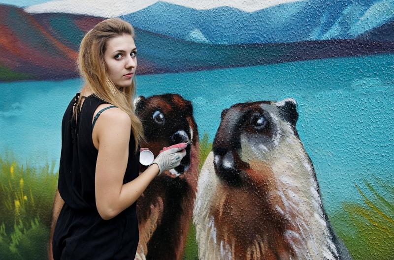 Художник-граффитист Мария Сухарева, участник проекта «Украсим город», делает граффити на одной из трансформаторных будок. Фото: «Вечерняя Москва».