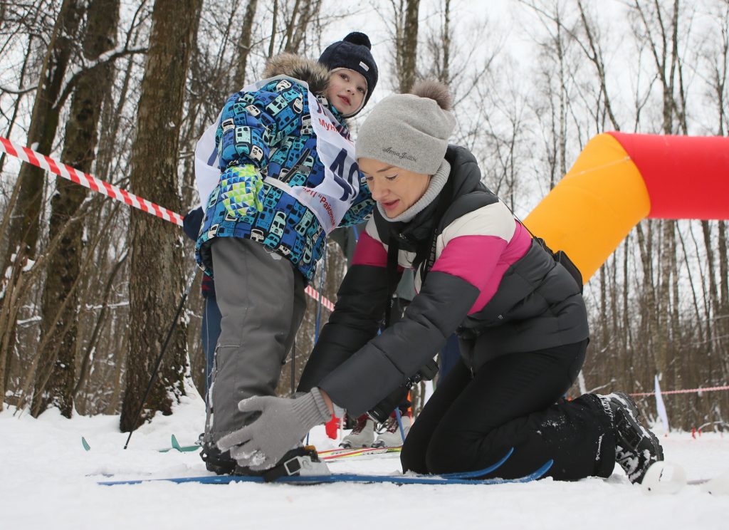28 января 2017 года. Московский. Мария Дружинина помогает сыну Игорю застегнуть крепления лыжных ботинок перед гонкой. Фото: Виктор Хабаров